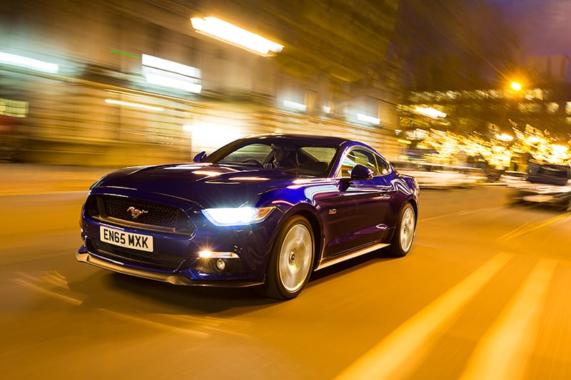 Blue Ford Mustang driving through a tunnel