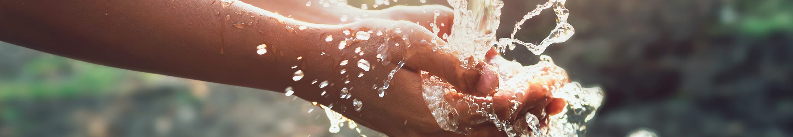 Childs hands cupping fresh water